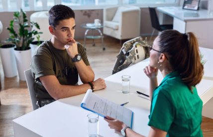 Female,Doctor,And,Worried,Military,Officer,Discussing,About,Problems,He